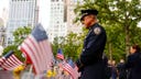 A police officer pays his respects at the 9/11 Memorial on Sept. 11, 2026.