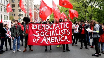 Members of the Democratic Socialists of America gather outside of a Trump-owned building on May Day on May 1, 2019, in New York City. - Fox Business News