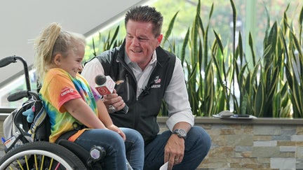 Matt Kaulig, owner of Kaulig Racing and Kaulig Giving, speaks with a young girl during a Speedy Bear Brigade as part of The NASCAR Foundation. - Fox Business News