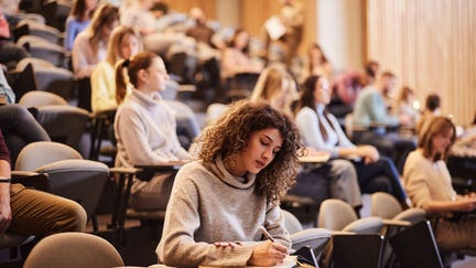 College students attend a lecture in a classroom. - Fox Business News
