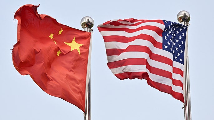 Chinese and U.S. flags waving