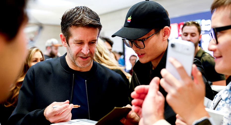 Apple CEO John Ternus signs an autograph at the Apple Store in New York City.