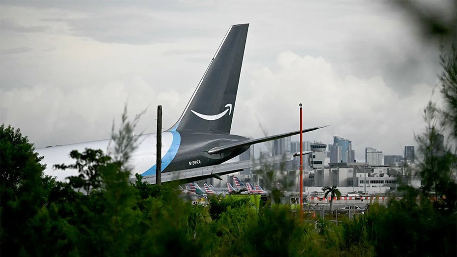 The airplane tail of a cargo plane that says Amazon