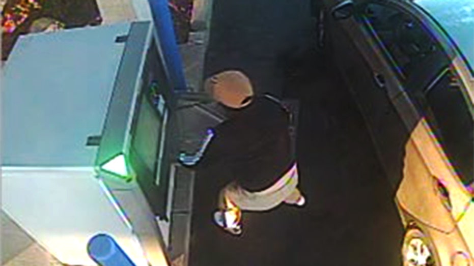A person breaks into an ATM.