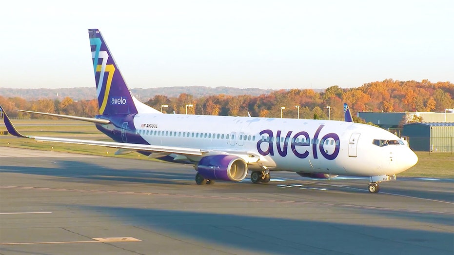 An Avelo Airlines aircraft parked on an airport tarmac.