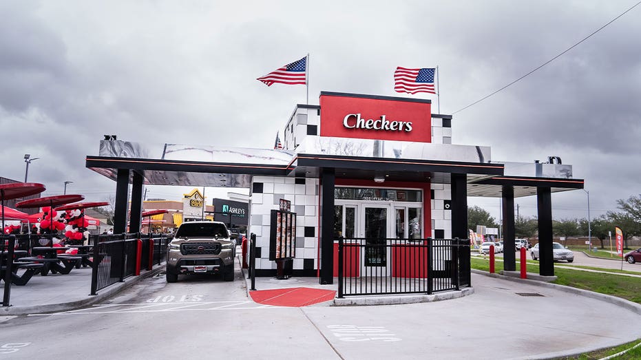Exterior of a Checkers restaurant in Baytown, Texas, with drive-thru lanes and outdoor seating