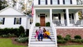 A family sits outside their home. - Fox News