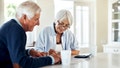 An older couple reviews their finances at their home table. - Fox News