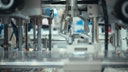 Close-up of a robotic arm or automated system precisely manipulating tiny components,