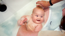 Baby getting bathed in a bath seat - Fox Business News