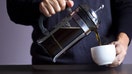 A person pours coffee out of a French press. - Fox Business News