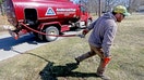Corey Carlson of Anderson Fuel walks towards a house to fill with home heating oil which has risen to over $5.00 a gallon on March 8, 2022, in Scituate, Massachusetts. - Fox Business News