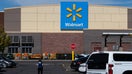 A Walmart employee walks through the customer parking lot near vehicles outside the storefront facade and corporate brand signage in Heber City, Utah, on Oct. 2, 2026. - Fox Business News