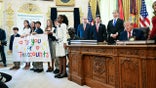Children hold up banner celebrating Trump Accounts at the White House.