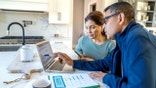 A woman and financial advisor at home.