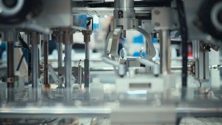 Close-up of a robotic arm or automated system precisely manipulating tiny components - Fox Business News