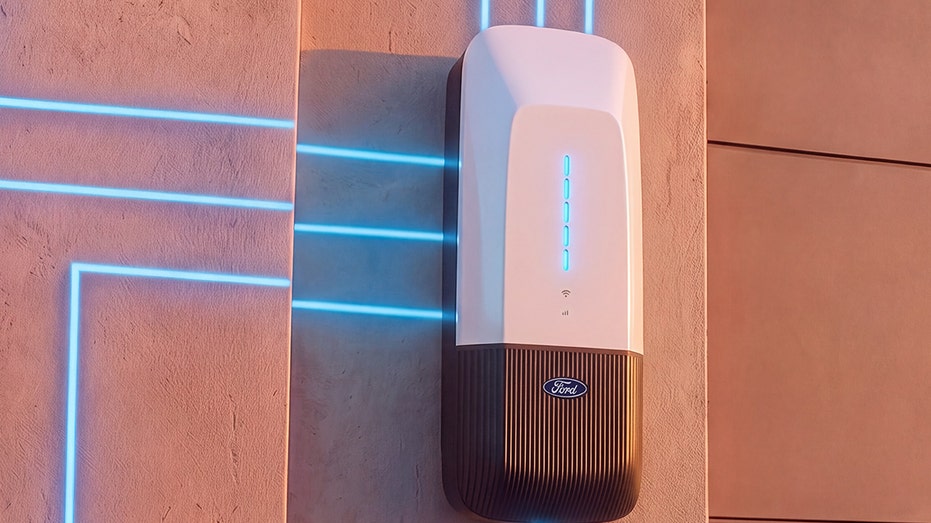 A Ford bidirectional charging system is shown mounted on a wall.