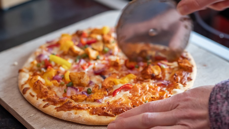 Slicing up a hot pizza