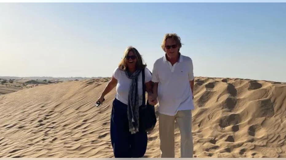 The Mortons walking in the sand