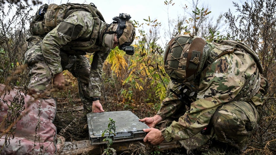 Soldiers from Ukraine's National Police set up Starlink terminal.