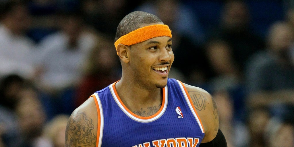 New York Knicks' Carmelo Anthony hold out three fingers on his