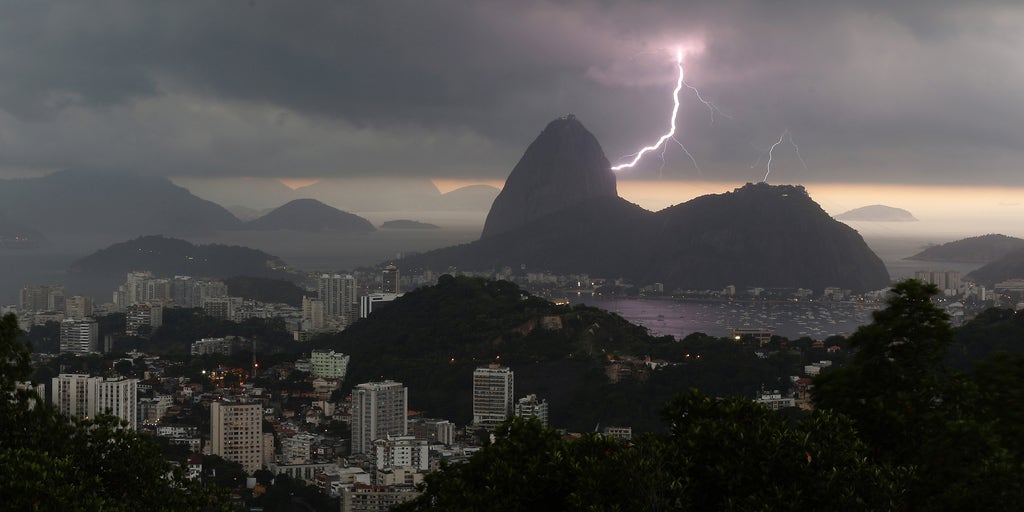 Violent storm sweeps over Rio de Janeiro, flooding streets and