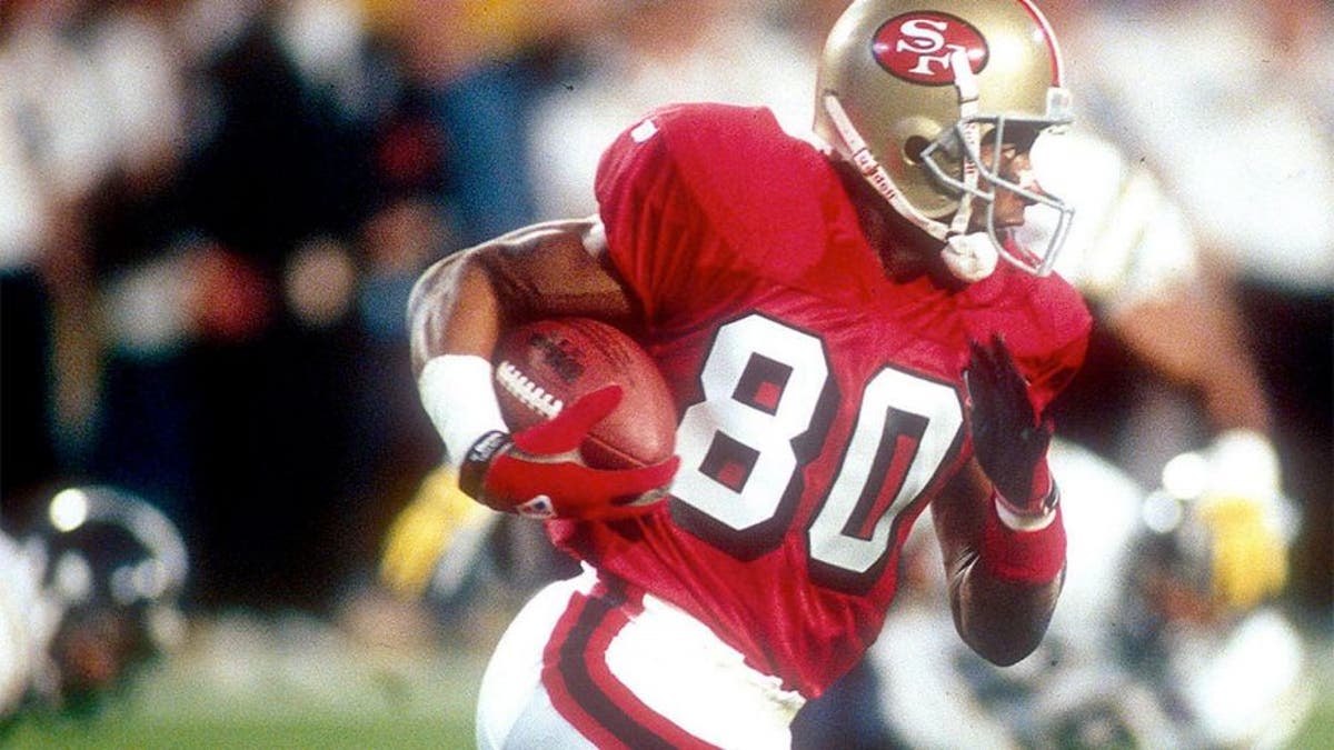 <p>Wider receiver Jerry Rice #80 of the San Francisco 49ers runs with the ball after a catch against the San Diego Chargers during Super Bowl XXIX on January 29, 1995 at Joe Robbie Stadium in Miami, Florida. The 49ers won the Super Bowl 49-26.</p>