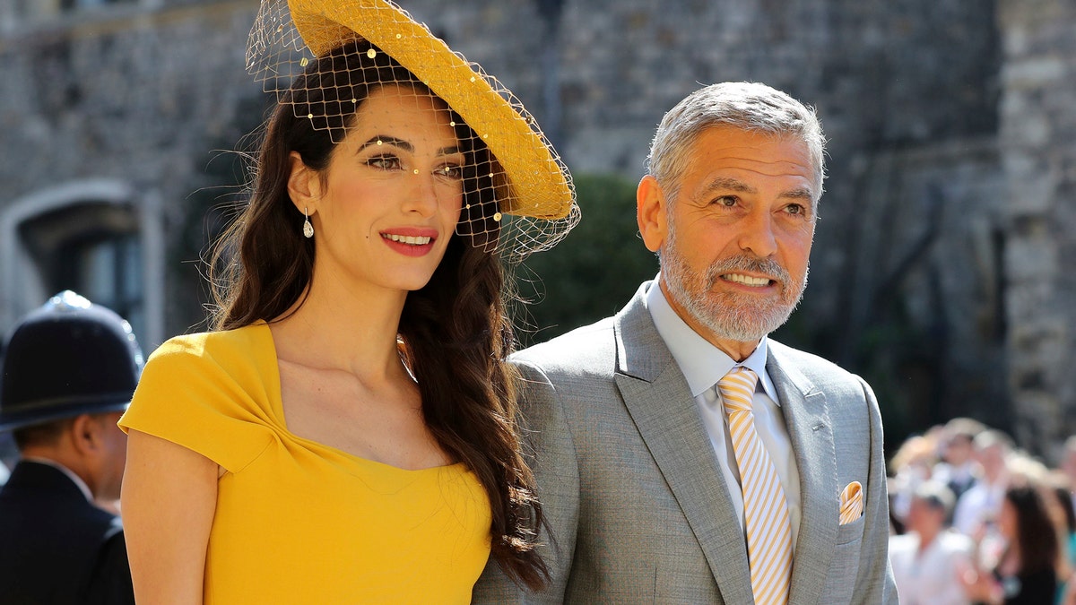 Amal Clooney and George Clooney arrive for the wedding ceremony of Prince Harry and Meghan Markle at St. George's Chapel in Windsor Castle in Windsor, near London, England, Saturday, May 19, 2018. (Gareth Fuller/pool photo via AP)