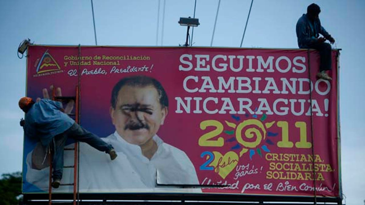 Workers remove a billboard with political propaganda supporting Nicaragua's current President Daniel Ortega that reads in Spanish "We keep changing Nicaragua: Christian, socialist, with solidarity" in Managua, Nicaragua, Thursday, Aug. 18, 2011. Religious processions and chants have become common in the re-election campaign rallies of leftist Nicaraguan President Daniel Ortega, who is highlighting his Christianity in his latest bid for presidency. (AP Photo/Esteban Felix)