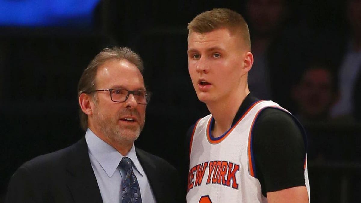 NEW YORK, NY - FEBRUARY 09: Interim Head Coach Kurt Rambis of the New York Knicks speaks to Kristaps Porzingis #6 during their game against the Washington Wizards at Madison Square Garden on February 9, 2016 in New York City. NOTE TO USER: User expressly acknowledges and agrees that, by downloading and/or using this Photograph, user is consenting to the terms and conditions of the Getty Images License Agreement. (Photo by Al Bello/Getty Images)