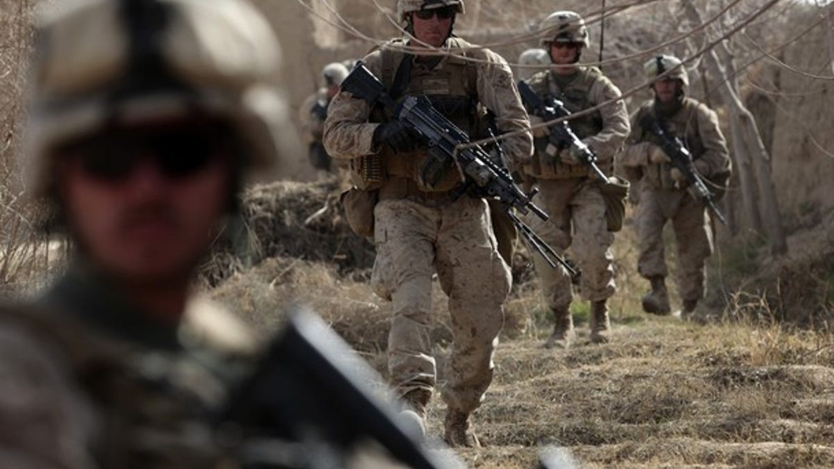 U.S. Marines from Bravo Company of the 1st Battalion, 6th Marines, walk in the town of Marjah in Nad Ali district of Helmand province February 15, 2010. U.S. Marines are making steady progress in one of the biggest NATO offensives in Afghanistan since the war began in 2001, but areas infested with roadside bombs are bogging them down, a spokesman said on Monday. REUTERS/Goran Tomasevic (AFGHANISTAN - Tags: CIVIL UNREST POLITICS)