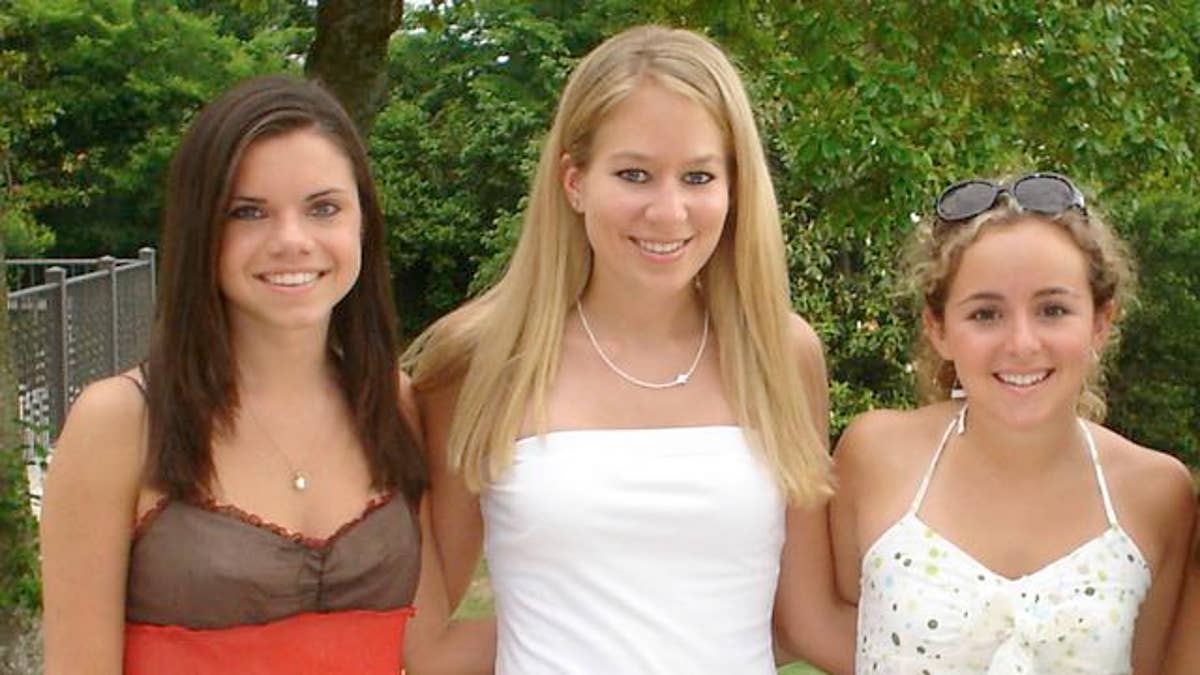 In this undated handout photo provided by Beth Twitty, Natalee Holloway, center, stands with high school friends Frances Bird, left, and Claire Fierman at their Mountain Brook High School senior banquet in Mountain Brook, Alabama in May 2005. The three friends attended their high school graduation trip to Aruba at which Holloway disappeared on May 30. (AP Photo/Courtesy of Beth Twitty, HO)