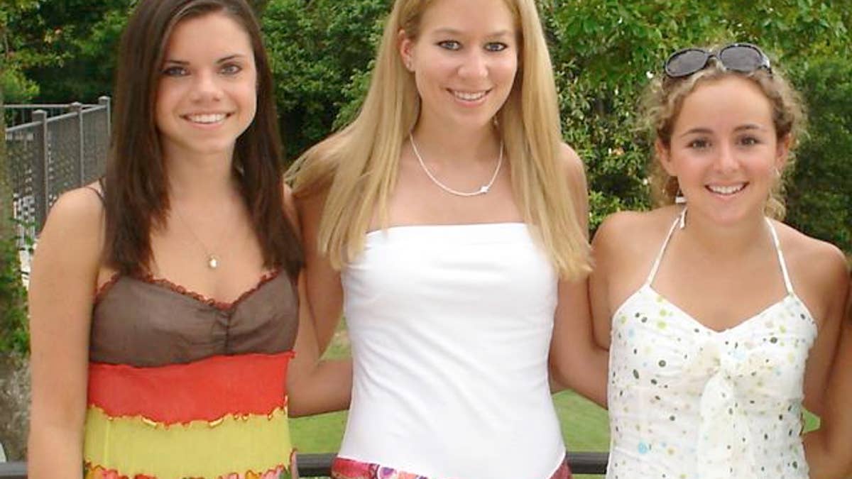 In this undated handout photo provided by Beth Twitty, Natalee Holloway, center, stands with high school friends Frances Bird, left, and Claire Fierman at their Mountain Brook High School senior banquet in Mountain Brook, Alabama in May 2005. The three friends attended their high school graduation trip to Aruba at which Holloway disappeared on May 30. (AP Photo/Courtesy of Beth Twitty, HO)