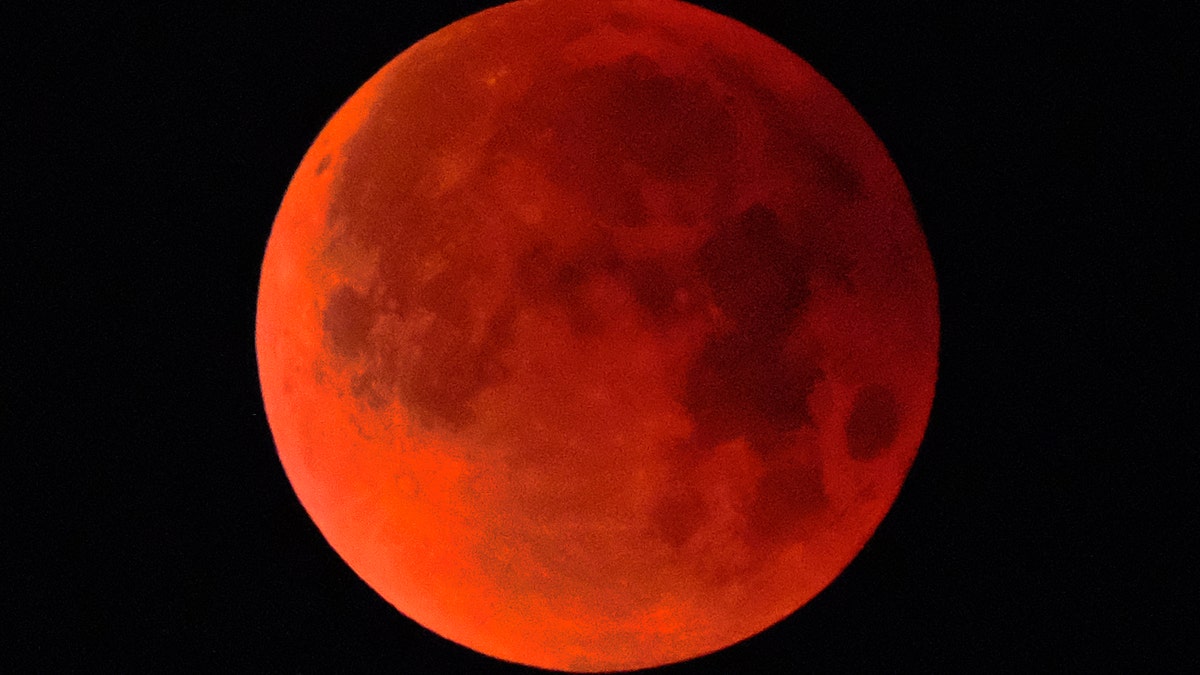 A super blue blood moon is seen over Los Angeles on Wednesday Jan. 31, 2018. The moon is putting on a rare cosmic show. It's the first time in 35 years a blue moon has synced up with a supermoon and a total lunar eclipse. NASA is calling it a lunar trifecta: the first super blue blood moon since 1982. That combination won't happen again until 2037.  (AP Photo/Richard Vogel)