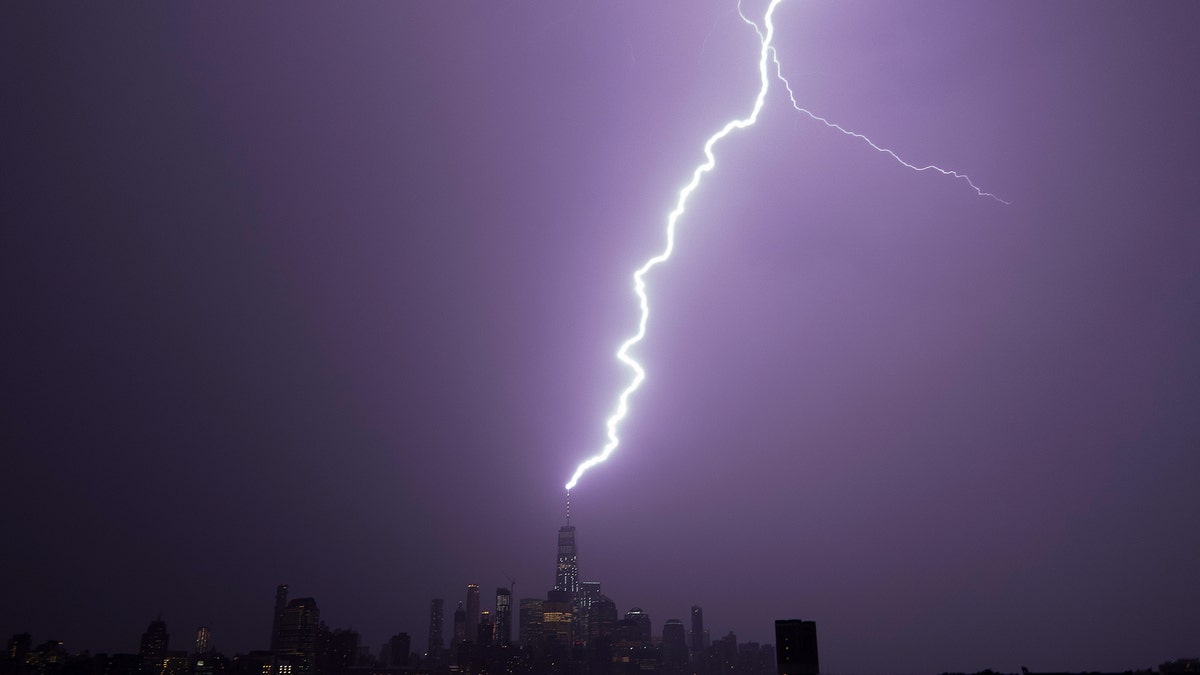 Lightning lights up the sky over lower Manhattan as a bolt strikes One World Trade Center in New York City on August 22, 2017 as seen from Hoboken, New Jersey.