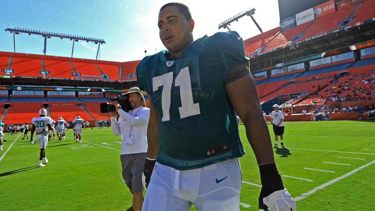 Aug. 4, 2012; Miami, FL, USA; Miami Dolphins tackle Jonathan Martin (71) heads towards the sidelines during a scrimmage at Sun Life Stadium. Mandatory Credit: Steve Mitchell-USA TODAY Sports
