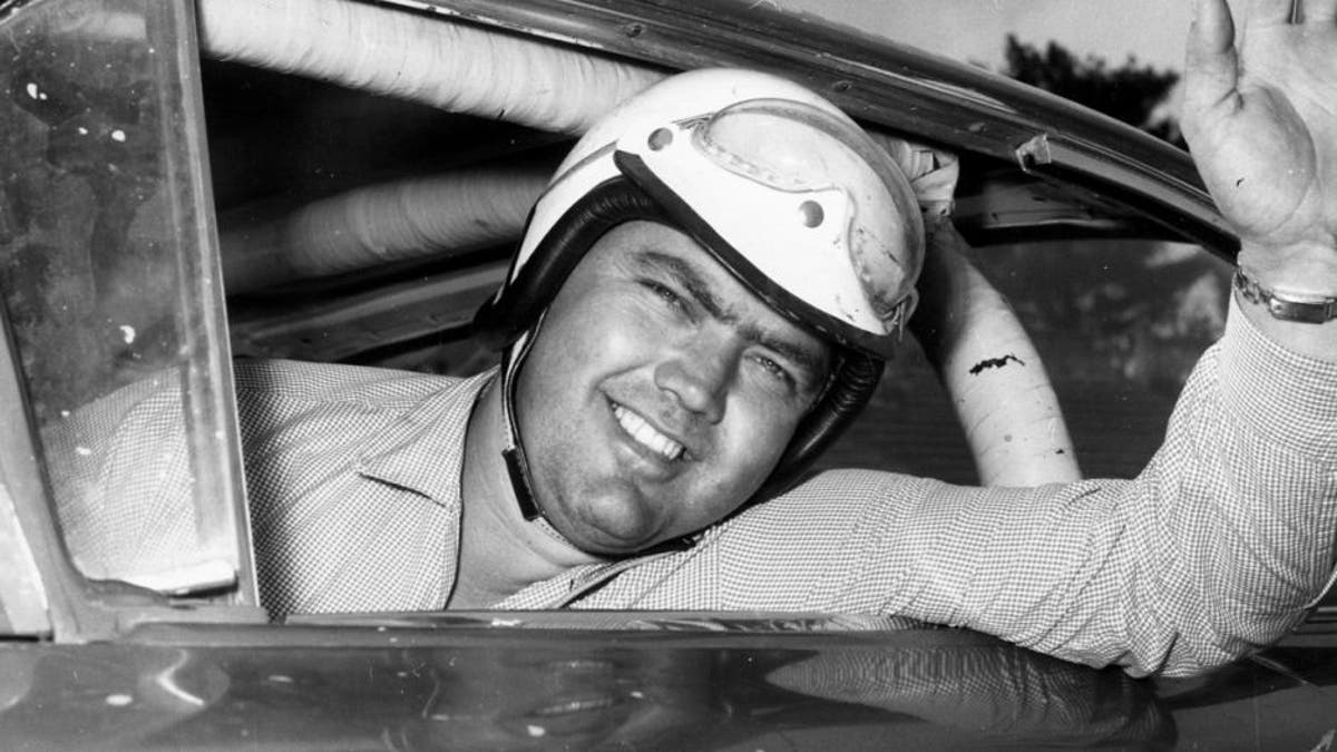 1959: Junior Johnson looks out his car window before a race. Johnson racked up 50 wins during his NASCAR Cup Series driving career, being named one of the organizationâs 50 Greatest Drivers. (Photo by: RacingOne/Getty Images) *** Local Caption *** Junior Johnson