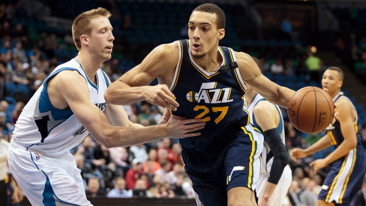 Mar 30, 2015; Minneapolis, MN, USA; Utah Jazz center Rudy Gobert (27) dribbles in the fourth quarter against Minnesota Timberwolves center Justin Hamilton (41) at Target Center. The Utah Jazz beat the Minnesota Timberwolves 104-84. Mandatory Credit: Brad Rempel-USA TODAY Sports