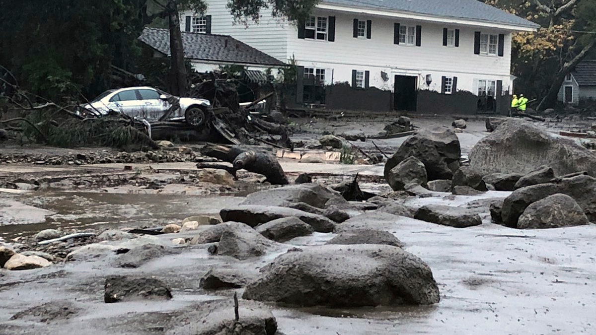 In this photo provided by Santa Barbara County Fire Department, mud and debris flow due to heavy rain in Montecito. Calif., Tuesday, Jan. 9, 2018. A fire official says five people have been killed by mudslides that swept Southern California homes from their foundations as a powerful storm drenched recent wildfire burn areas.  (Mike Eliason/Santa Barbara County Fire Department via AP)