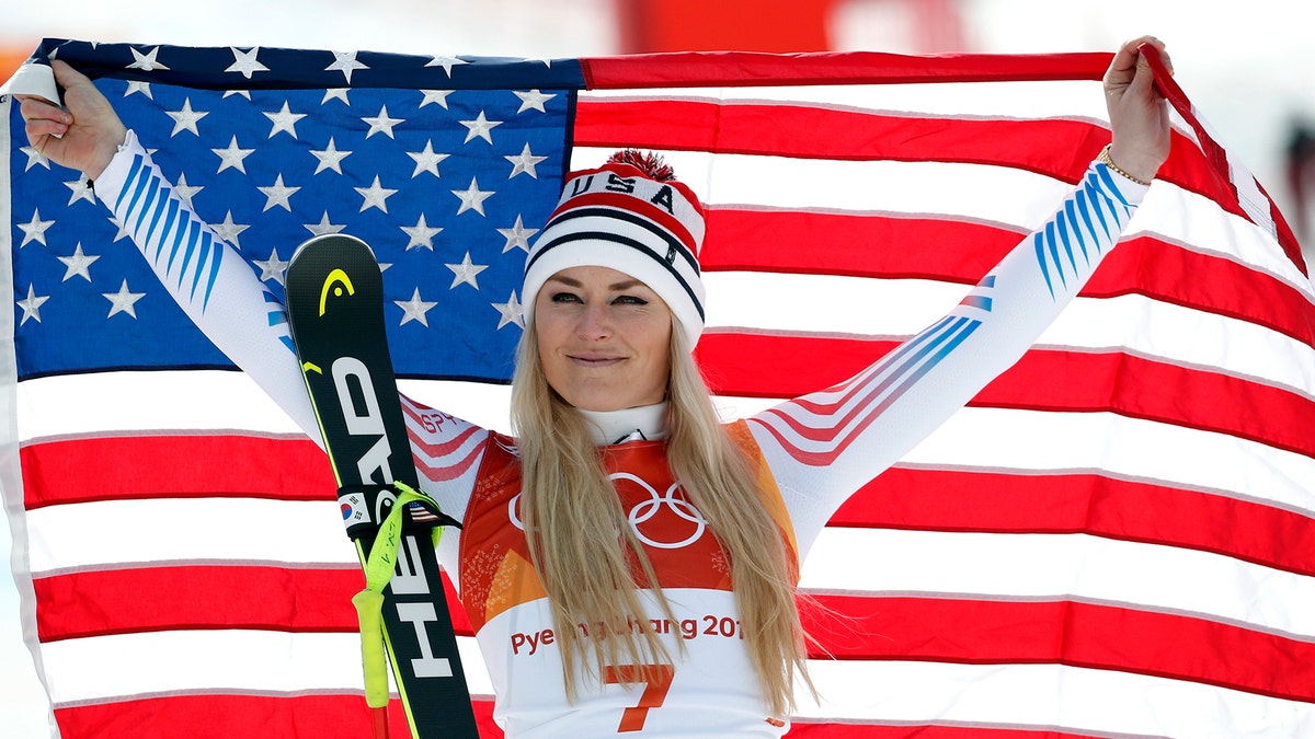 Bronze medal winner Lindsey Vonn, of the United States, celebrates during the flower ceremony for the women's downhill at the 2018 Winter Olympics in Jeongseon, South Korea, Wednesday, Feb. 21, 2018. (AP Photo/Christophe Ena)