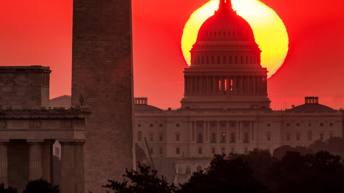 The sun rises behind the U.S. Capitol in Washington at dawn Wednesday, Sept. 19. 2018. (AP Photo/J. David Ake)