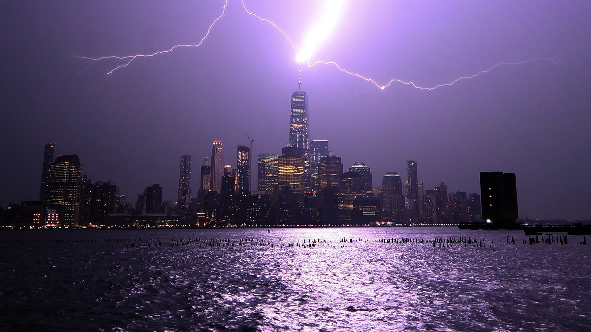 HOBOKEN, NJ - AUGUST 22: Lightning lights up the sky over lower Manhattan as a bolt strikes One World Trade Center in New York City on August 22, 2017 as seen from Hoboken, New Jersey. (FOX News/Gary Hershorn)