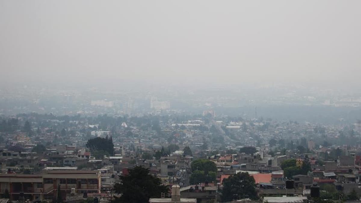 Air pollution hangs over Mexico City, Tuesday, May 3, 2016. Mexico City authorities have declared a new pollution alert and will require 40 percent of cars to keep off the streets. (AP Photo/Eduardo Verdugo)