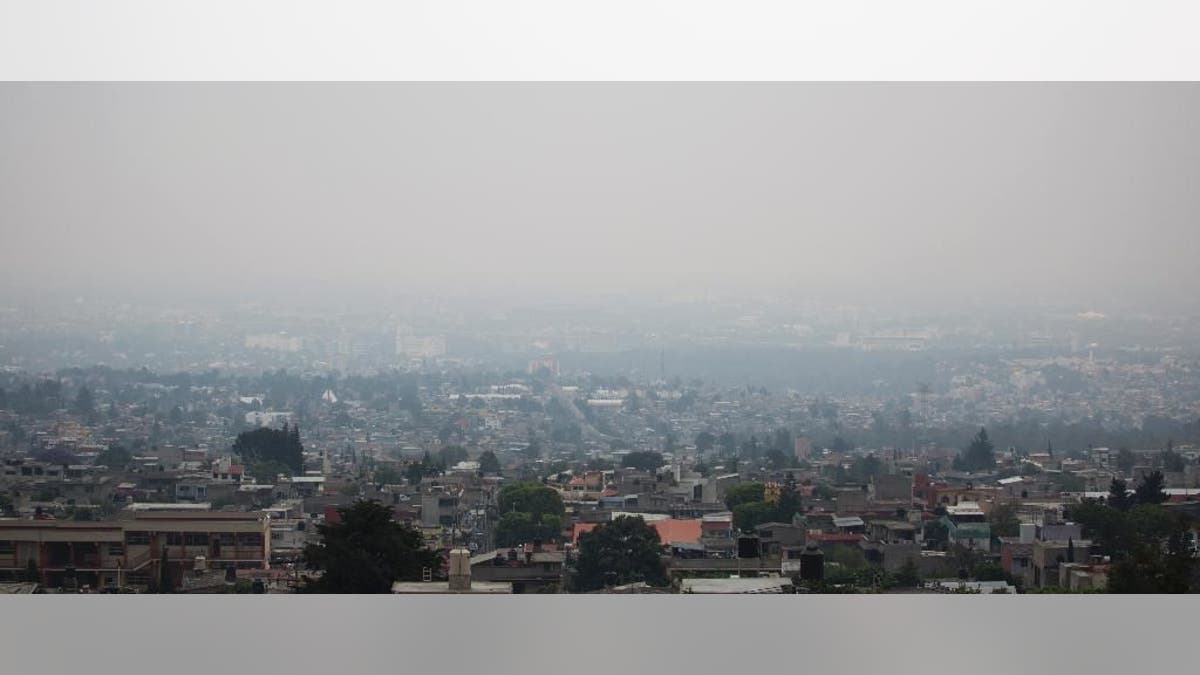 Air pollution hangs over Mexico City, Tuesday, May 3, 2016. Mexico City authorities have declared a new pollution alert and will require 40 percent of cars to keep off the streets. (AP Photo/Eduardo Verdugo)