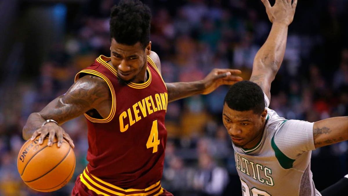 Apr 12, 2015; Boston, MA, USA; Cleveland Cavaliers guard Iman Shumpert (4) works the ball against Boston Celtics guard Marcus Smart (36) in the first half at TD Garden. The Celtics defeated the Cleveland Cavaliers 117-78. Mandatory Credit: David Butler II-USA TODAY Sports