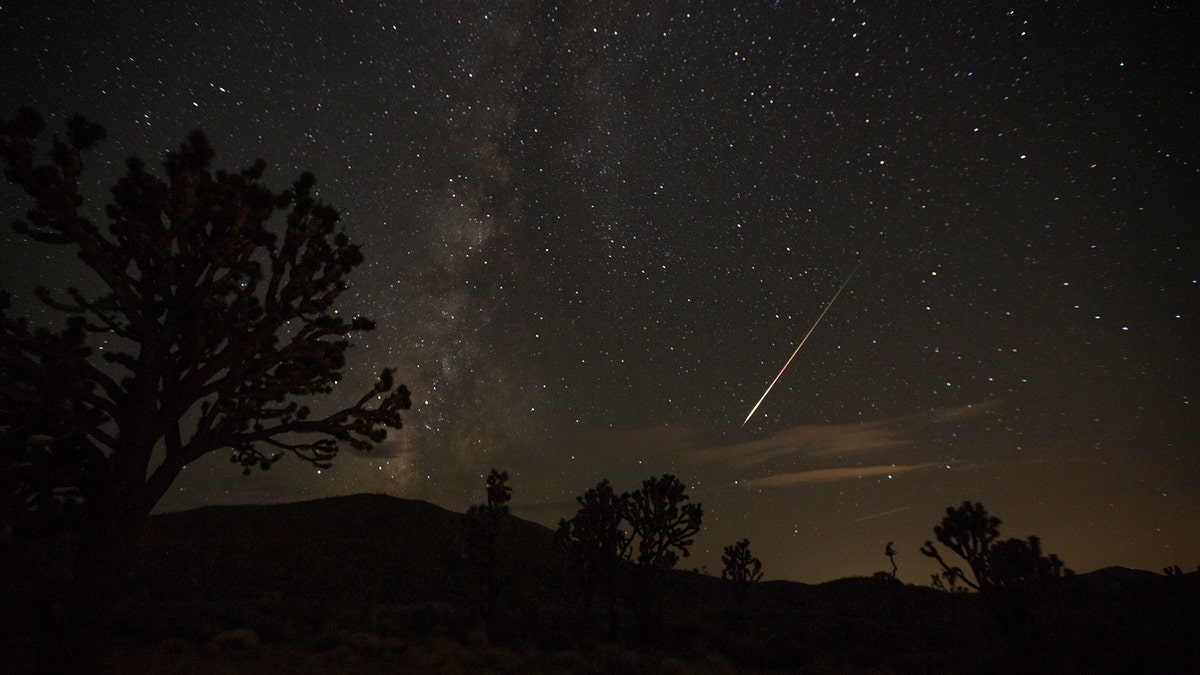 A streak from the Perseid meteor shower shoots above the Mojave Desert as seen from Nevada State Route 164, also known as the Joshua Tree Highway, about 10 miles west of Searchlight, Nev., early Monday, Aug. 13, 2018. (Richard Brian/Las Vegas Review-Journal via AP)