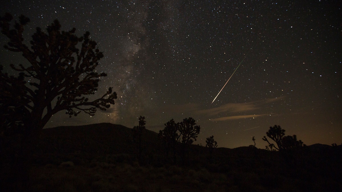 A streak from the Perseid meteor shower shoots above the Mojave Desert as seen from Nevada State Route 164, also known as the Joshua Tree Highway, about 10 miles west of Searchlight, Nev., early Monday, Aug. 13, 2018. (Richard Brian/Las Vegas Review-Journal via AP)