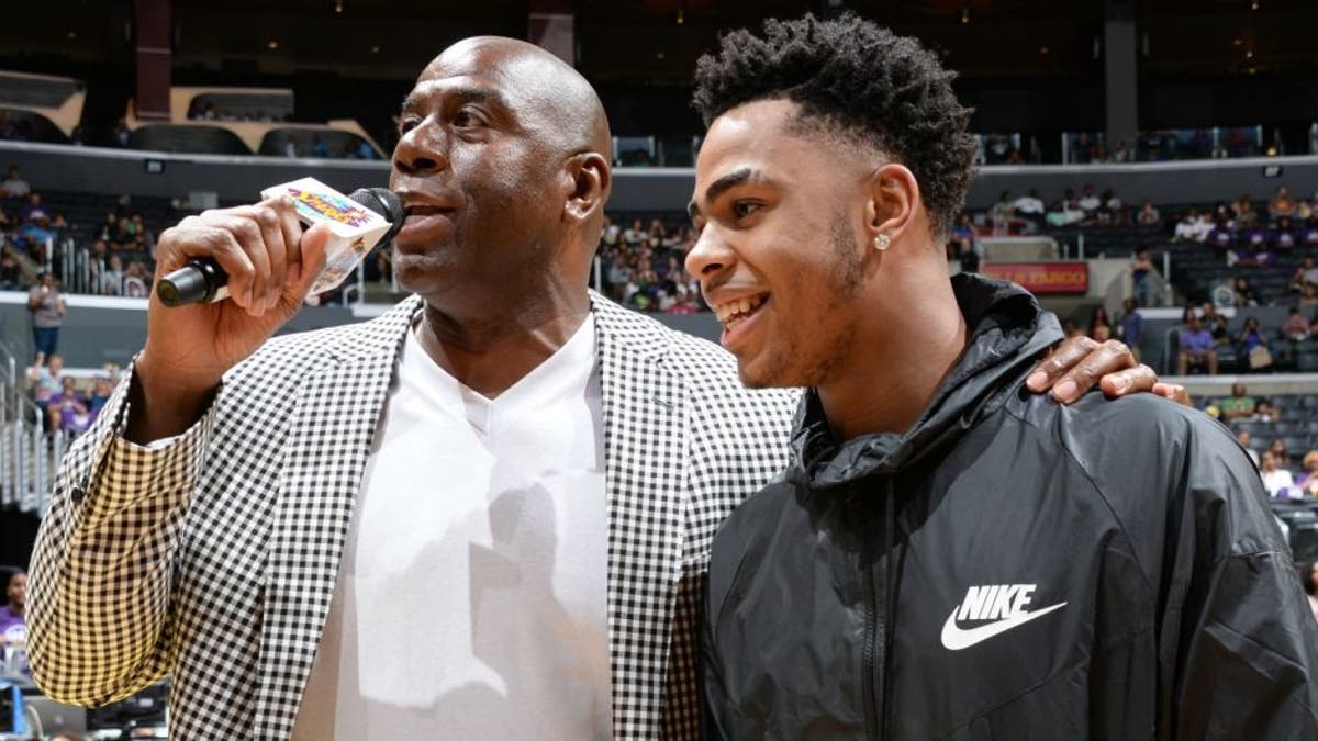 LOS ANGELES, CA - AUGUST 30: Los Angeles Sparks Owner Magic Johnson interviews D'Angelo Russell #1 of the Los Angeles Lakers during a game between the Los Angeles Sparks and the San Antonio Stars at STAPLES Center on August 30, 2015 in Los Angeles, California. NOTE TO USER: User expressly acknowledges and agrees that, by downloading and/or using this Photograph, user is consenting to the terms and conditions of the Getty Images License Agreement. Mandatory Copyright Notice: Copyright 2015 NBAE (Photo by Andrew D. Bernstein/NBAE via Getty Images)