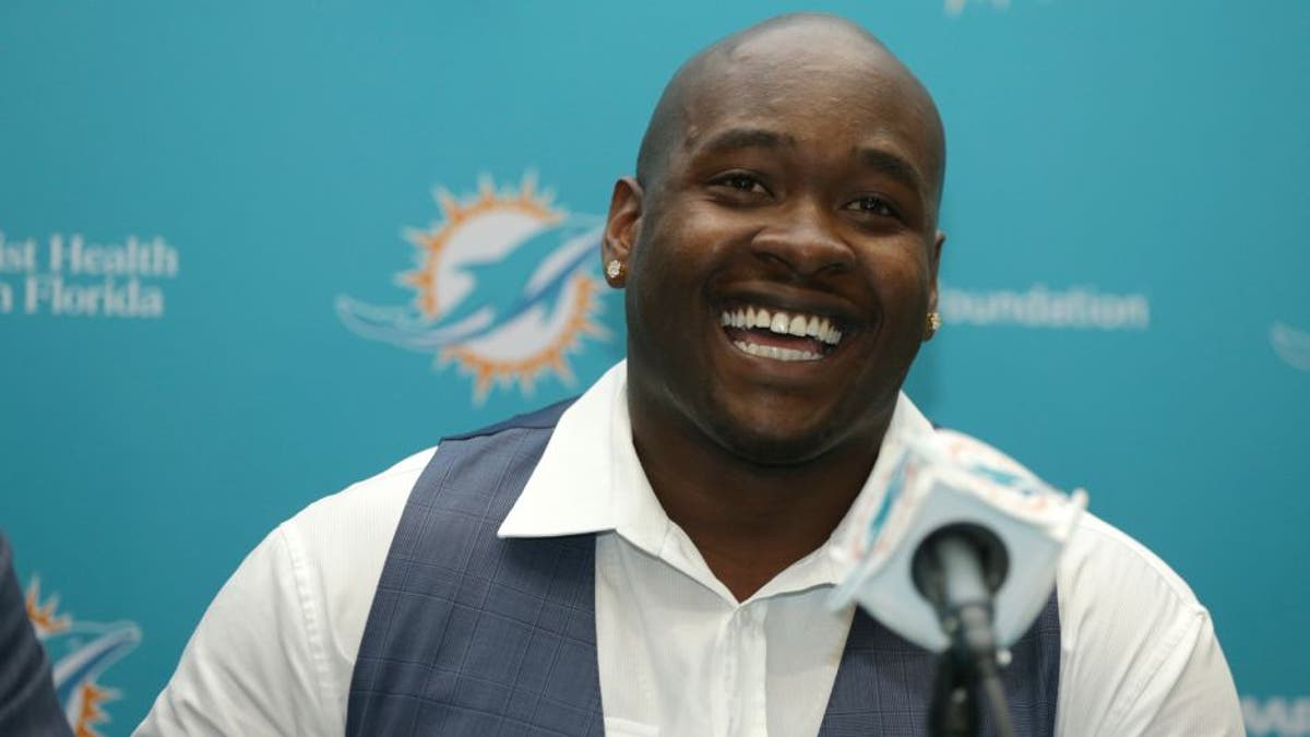 FILE - In this April 29, 2016, file photo, top Miami Dolphins draft pick Laremy Tunsil smiles during a news conference, in Davie, Fla. Tunsil and the Dolphins were quick to agree on his value in the wake of his NFL draft freefall. The offensive lineman from Ole Miss signed his rookie contract before joining the Dolphins' rookie minicamp which began Friday, May 6, 2016. (AP Photo/Lynne Sladky)
