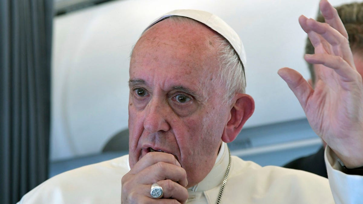 Pope Francis addresses journalists during the traditional press conference on his flight back to Rome, following a two-day visit at Fatima, Portugal, Saturday, May 13, 2017. Pope Francis added two Portuguese shepherd children to the roster of Catholic saints Saturday, honoring young siblings whose reported visions of the Virgin Mary 100 years ago turned the Portuguese farm town of Fatima into one of the world's most important Catholic shrines. (Tiziana Fabi/Pool Photo via AP)